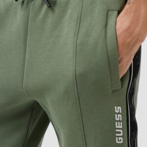 GUESS Zielone męskie spodnie dresowe z lampasami Mickey