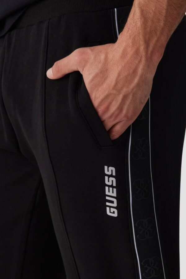 GUESS Czarne męskie spodnie dresowe z lampasami Mickey