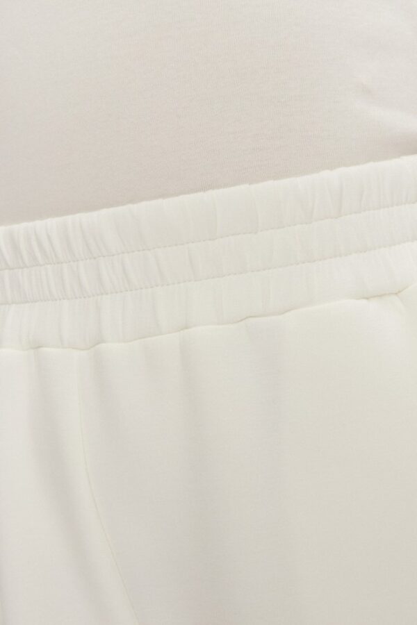 GUESS Dresowe damskie spodnie w kolorze ecru Cecilia Scuba